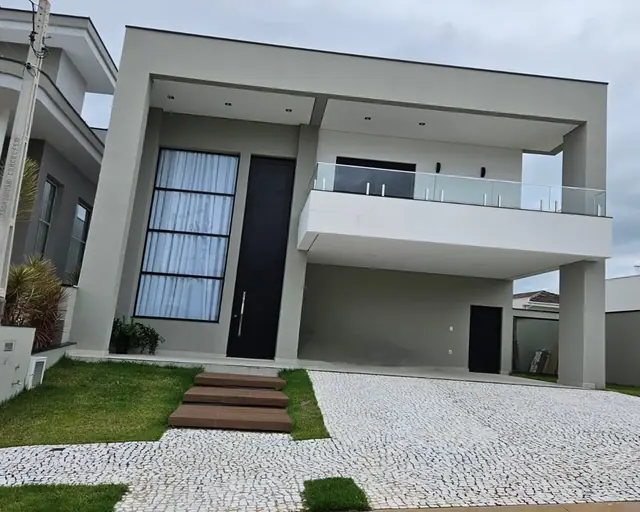 Fachada de casa entregue no Swiss Park Biel, com dois pavimentos e varanda de vidro